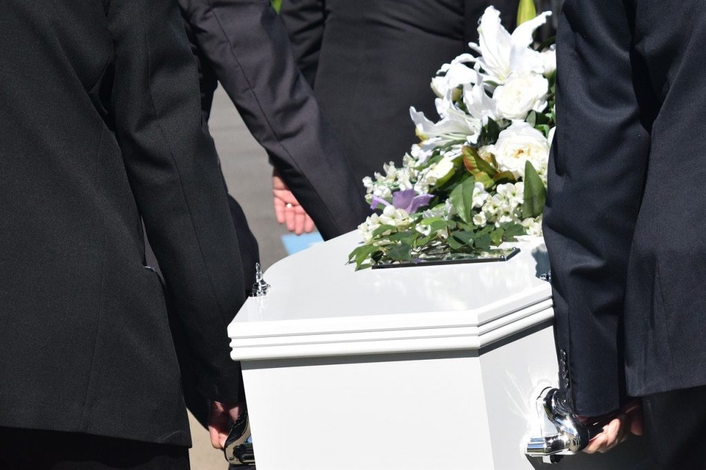 men carrying coffin at funeral